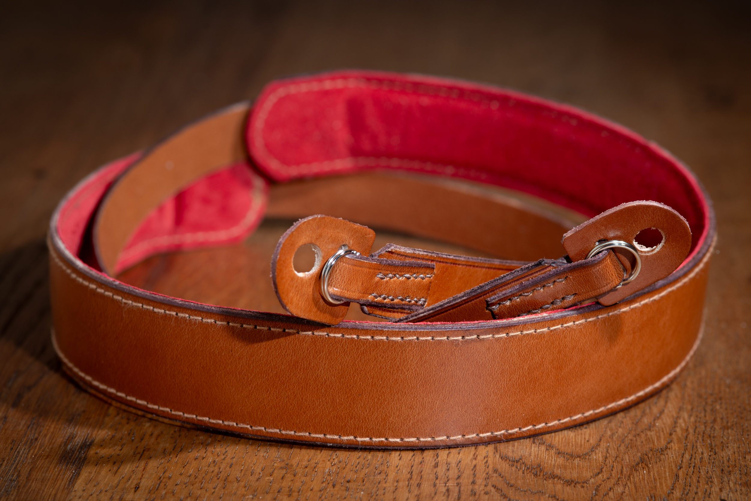 Rich brown camera strap with shoulder pad and tabs